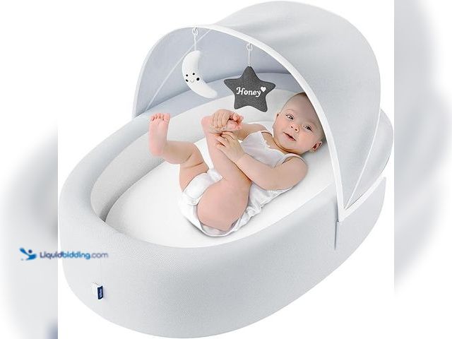 Lot 49-3472739 - Premium Portable Baby Lounger Nest – Foldable Travel Bassinet for Newborn & Infant with Mesh Canopy,...