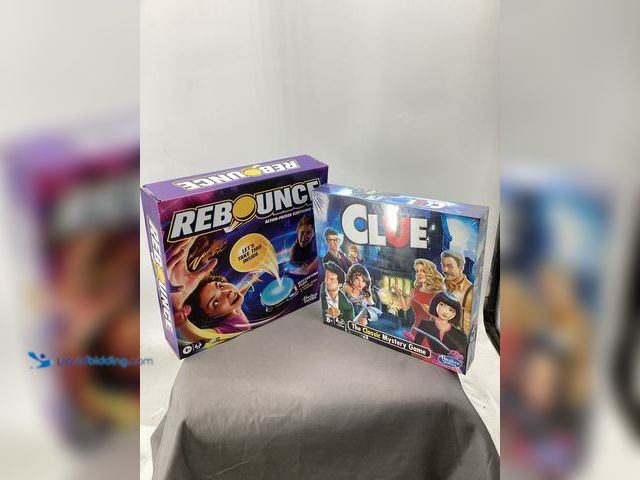 Lot 49-911490 - Lot of 2 Board Games New and Unopened. Games include Clue and Rebounce.