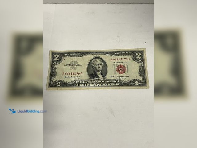 Lot 49-910569 - Series 1963 $2 United States Note featuring the distinctive red Treasury seal and serial numbers. Th...