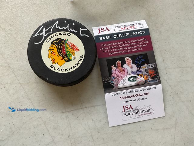 Lot 49-1830521 - COLLECTIBLE CHICAGO BLACK HAWKS SUPERSTAR STAN MIKITA AUTOGRAPHED HOCKEY PUCK WITH JSA COA #COINS021...