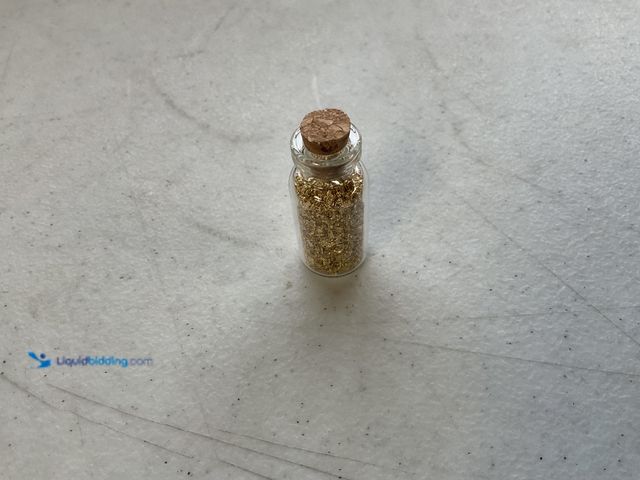 Lot 49-1804564 - ONE INCH GLASS VILE OF PURE 24KGOLD FLAKES.