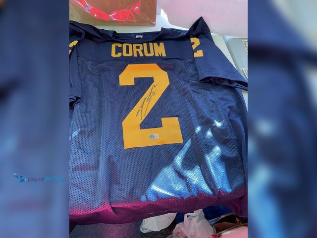 Lot 49-1811263 - COLLECTIBLE U OF M BLAKE CORUM AUTOGRAPHED STITCHED JERSEY WITH BECKETT WITNESS STICKER COA