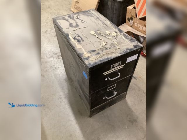 Lot 49-5573157 - Black 2 Tier Filing Cabinet, Used with scuffs, dirty, no key, bent lock, Has caulk on top