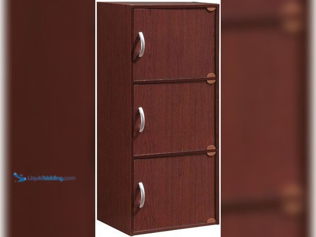 Lot 49-5459486 - Hodedah 3 Door Bookcase Cabinet, MAHOGANY. Model #B0051HH604. Unused with attachments.