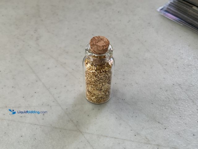 Lot 49-1810334 - ONE INCH GLASS VILE OF PURE 24K GOLD FLAKES