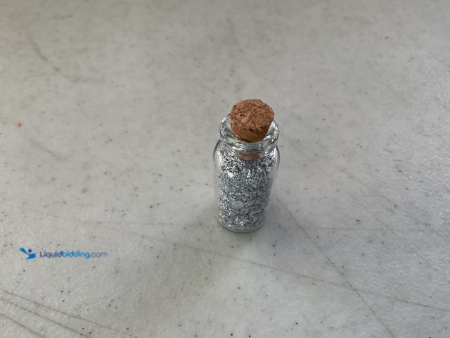 Lot 49-1810332 - ONE INCH GLASS VILE OF PURE SILVER FLAKES