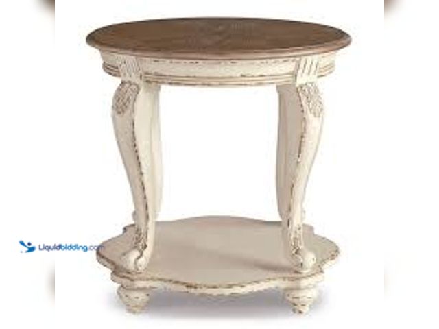 Lot 49-5415222 - Signature DESIGN BY ASHLEY Realyn 26 in. 2-Toned Round Wood End Table. Model # T743-6. Unused. Dents...