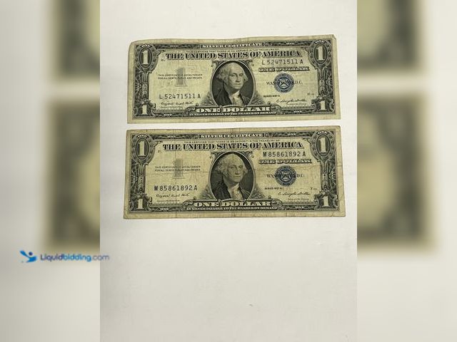 Lot 49-910567 - Lot of (2) Series 1957A $1 Silver Certificates featuring the classic blue Treasury seal and serial n...