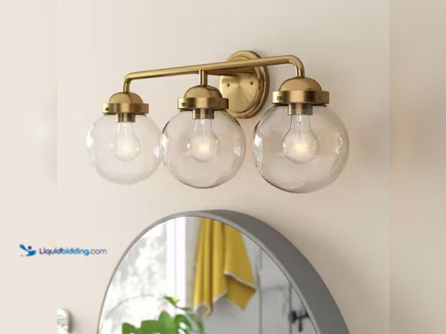 Lot 49-2001485 - Designers Fountain Knoll 24 in. 3-Light Brushed Gold Retro Vanity Light with Clear Glass Shades, Mod...
