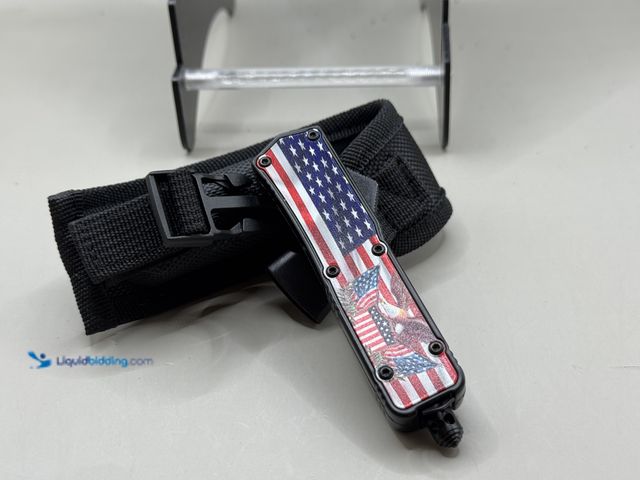 Lot 49-1831431 - New Outfront, American flag automatic knife Brand new blade length 2 5/8 overall length 7 inches com...