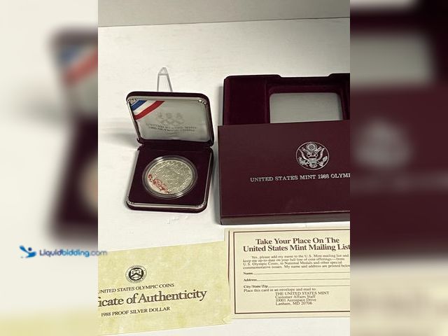 Lot 49-910564 - Official 1988 United States Olympic Games Proof Silver Dollar issued by the U.S. Mint to commemorate...