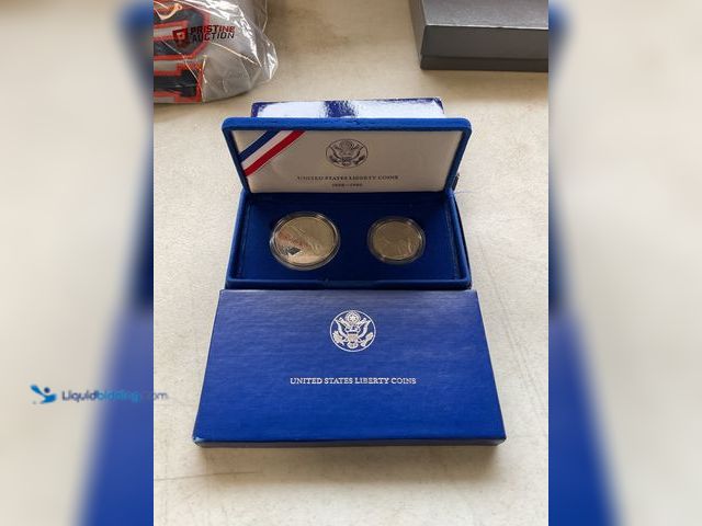 Lot 49-1505496 - 1986 UNITED STATES LIBERTY COINS SET OF 2 SILVER DOLLAR AND HALF DOLLAR PROOF COINS. #COINS0122