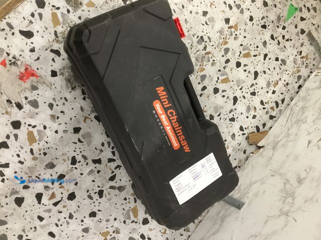 Lot 49-5478771 - Mini Chainsaw Item is used, dirty, includes Battery & Charger, Tested/works, includes case.