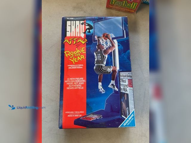 Lot 49-1830639 - COLLECTIBLE SHAQ ATTAQ ROOKIE OF THE YEAR 6 INCH FIGURE WITH BACKBOARD HOOP AND NET IN SEALED BOX #C...
