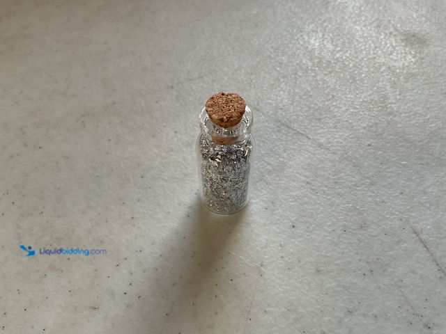 Lot 49-3503560 - RARE ONE INCH GLASS VILE OF PURE SILVER FLAKES