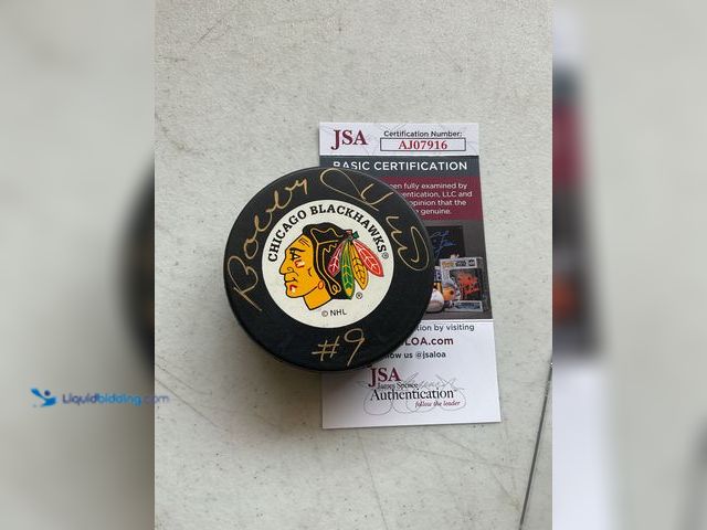 Lot 49-1801466 - CHICAGO BLACKHAWKS HALL OF FAMER BOBBY HULL AUTOGRAPHED HOCKEY PUCK