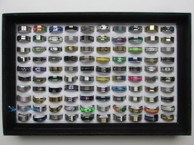 Lot 49-3435326 - Bulk Lot of 100 Stainless Steel Rings in Retail Display Box - NEW - Includes Men's and Women's Sizes...