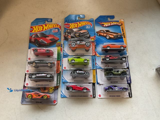 Lot 49-5341592 - LOT OF 12 NEW /64 SCALE DIECAST HOT WHEELS CARS IN ORIGINAL PACKAGES VARIOUS MAKES AND MODELS