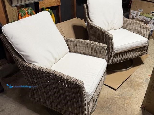 Lot 49-1630689 - Hampton Bay Holly Cove 2 Piece Brown Rattan Wicker Patio Swivel Armchairs With Almond Cushions, Unus...