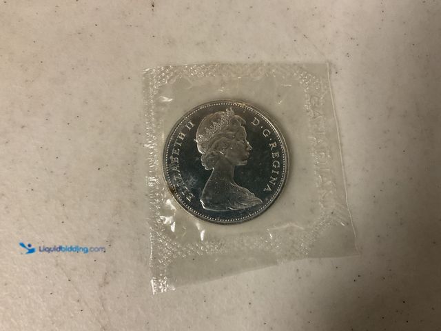 Lot 49-1804595 - 1965 CANADIAN ONE DOLLAR COIN