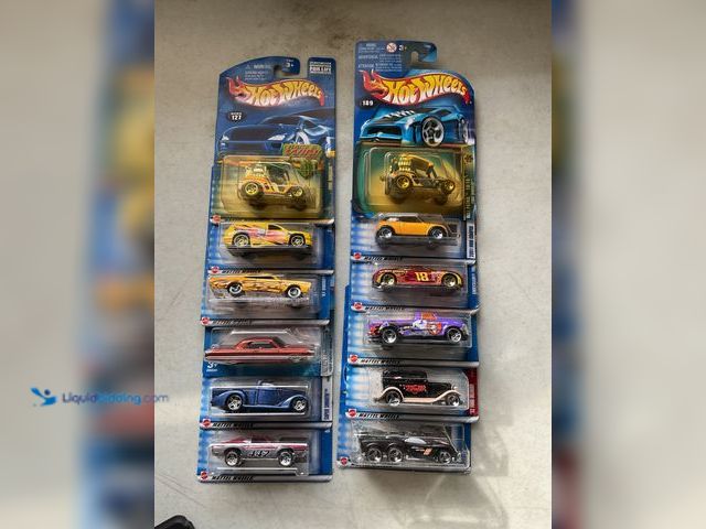 Lot 49-1830737 - COLLECTIBLE LOT OF 12 HOT WHEELS 1/64 SCALE DIECAST CARS IN ORIGINAL PACKAGES VARIOUS MAKES AND MODE...