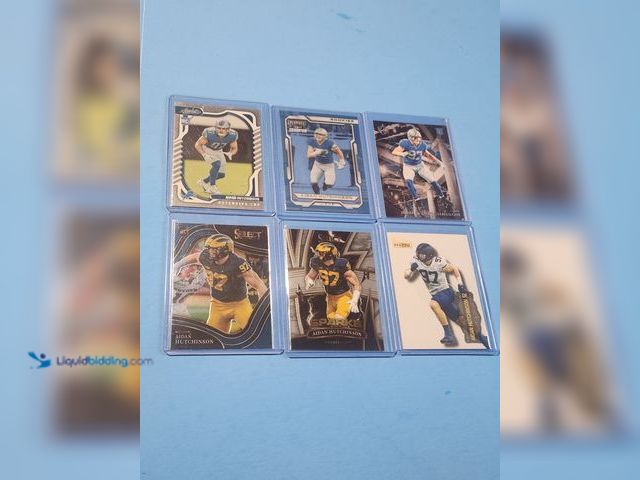 Lot 49-1817769 - 6- COLLECTIBLE AIDAN HUTCHINSON ROOKIE FOOTBALL CARDS. VARIOUS BRANDS AND ALL CARDS ARE IN PROTECTIV...