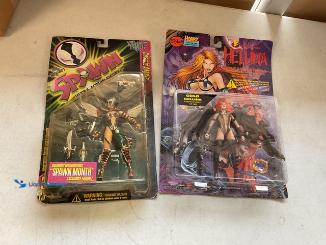 Lot 49-5341521 - LOT OF 2 NEW IN PACKAGE ACTION FIGURES INCLUDING SPAWN COSMIC ANGELA AND HELLINA