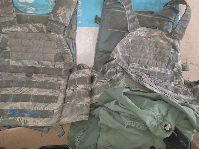 Lot 49-1830347 - Lot of military items. Including  jackets and gun holsters.