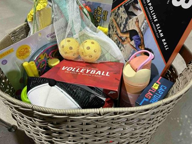Lot 499-214 - Summer basket-
Includes: pickleball set (2 rackets, 2 balls); paddleball set (2 rackets, 2 balls); 5...
