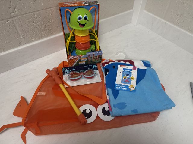 Lot 499-016 - Beach Day! 
Beach tote bag 
Waterpillar sprinkler
H20 swim goggles 
Crab water blaster 
Baby shark b...