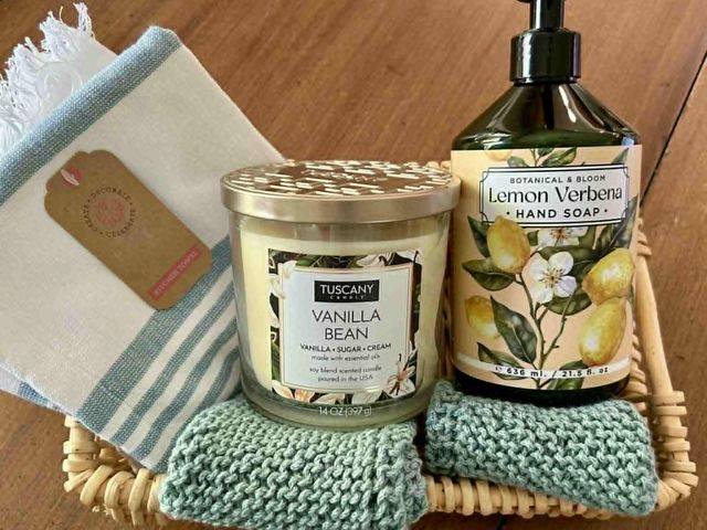 Lot 499-284 - Kitchen Basket- includes: 2 homemade dishcloths, Tea Towel, Vanilla Bean Soy Blend Candle, Botanical...