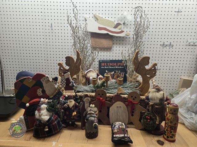 Lot 53-623 - Large Basket filled with Santa Claus Figurines, Angel Wooden Candle Centerpiece, and other Christmas...