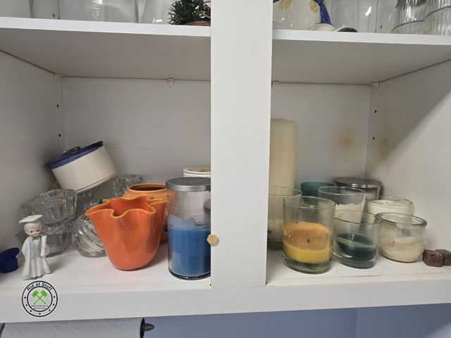 Lot 53-566 - Contents of Cabinet - Mostly Candles, Candle Holders, Wax Warmer, and other misc pieces. Bring boxes...