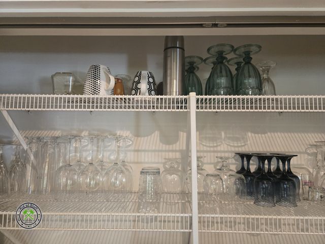 Lot 53-557 - Shelf Contents - Top 2 Shelfs - Glassware, Coffee Mugs and more! Bring boxes to load.
