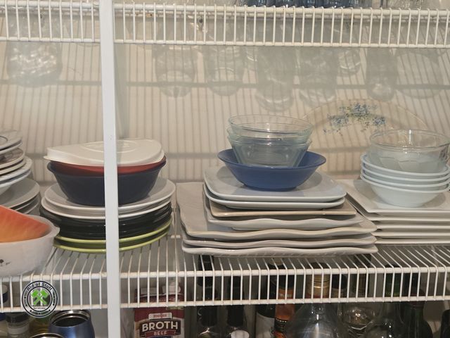 Lot 53-558 - Contents of shelf - Includes: Orange Fire King Bowl, Plates, Bowls and more - Bring boxes to load.