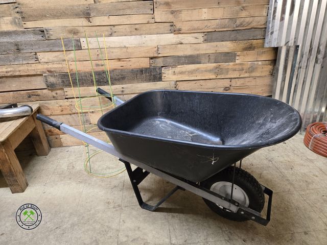 Lot 53-2039 - Wheel Barrow with 2 Metal Tomato Cages - Tire needs air, there is a crack in the bottom of the barro...