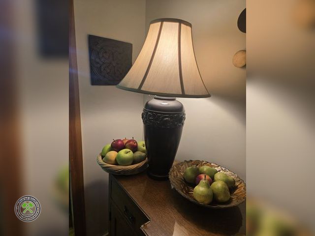 Lot 53-553 - Home Decor Lot - Includes: Table Top Lamp, Wicker basket full of faux fruit, metal leaf patterned de...