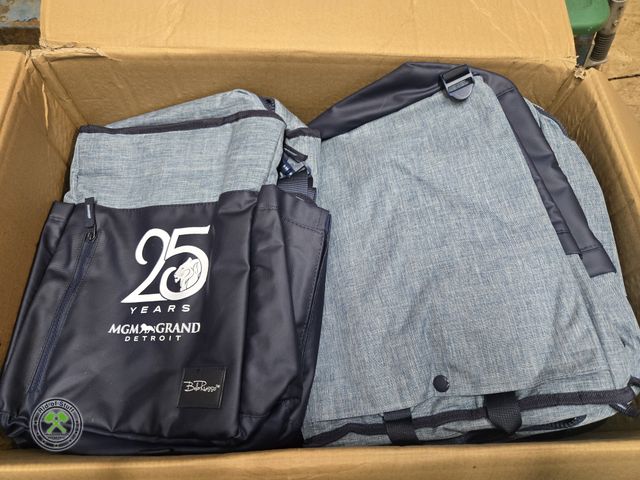Lot 53-1025 - Large Box of Brand New Backpacks and Insulated Bags with the 25 year MGM Grand Detroit Logo on them!...