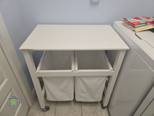 Lot 53-652 - White Laundry Hamper on wheels with table top that lifts up for easy access - Measures: 29"x18"x34" ...