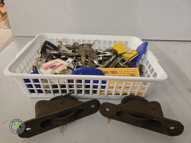 Lot 53-549 - Basket full of old keys and old cast iron curtain pulleys (B5B)