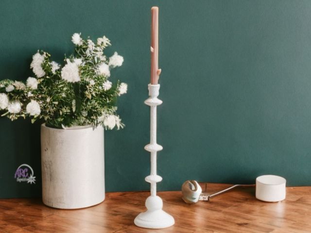 Lot 56-334418 - New in box, tall and elegant taper candle holder made of metal, featuring a sand finish and an antiq...