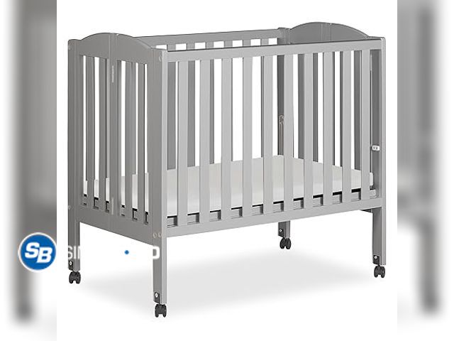 Lot 58-35311 - Dream On Me 2 in 1 Folding Portable Crib in Cool Grey, - appears unused - damaged box
