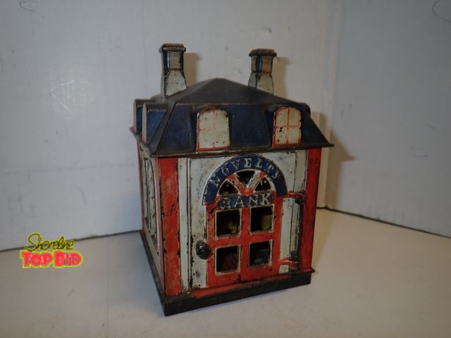 Lot 59-14104 - Original Antique J &amp; E Stevens Co. Cast Iron Bank. When the hinge door opens, a bank teller hold...