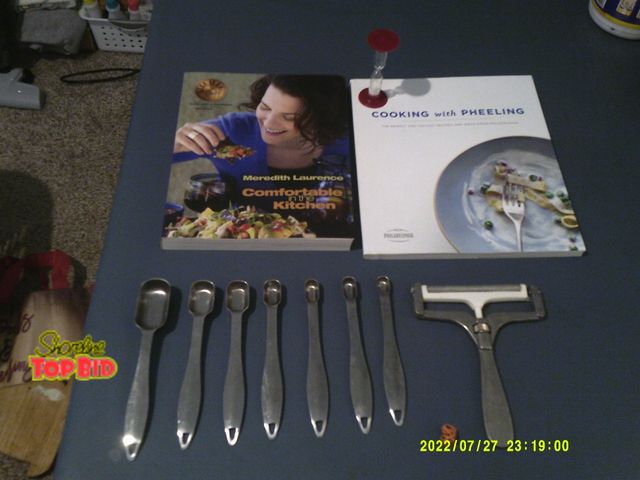 Lot 59-86035 - Two wonderful cook books and metal utensils, books "comfortable in the kitchen and cooking with phee...