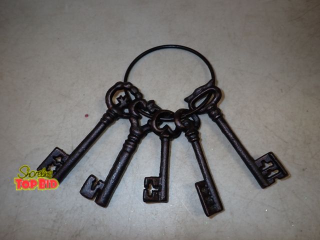 Lot 59-41655 - Set of 5 faux metal Skelton key's they measure from 3" to 4" in length the circle holder is 3 1/4" i...