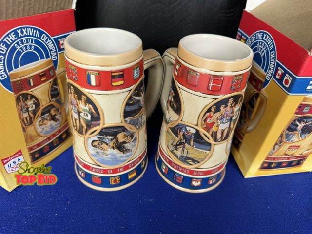 Lot 59-20189 - A Budweiser Stein pair commemorating the 1988 Seoul Olympiad - new in boxes