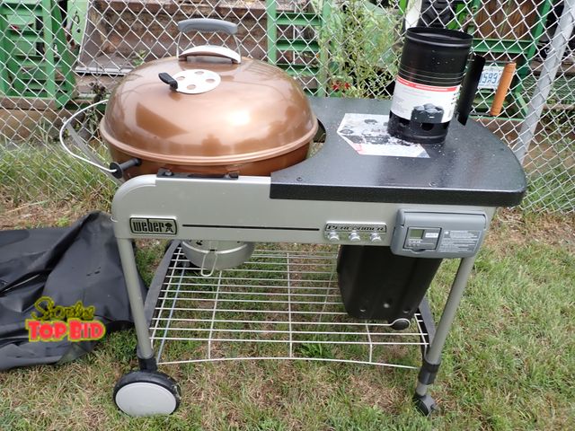 Lot 59-21009 - Weber Performer Deluxe 22" Charcoal Grill in copper with propane gas starter comes with 3 cans of pr...