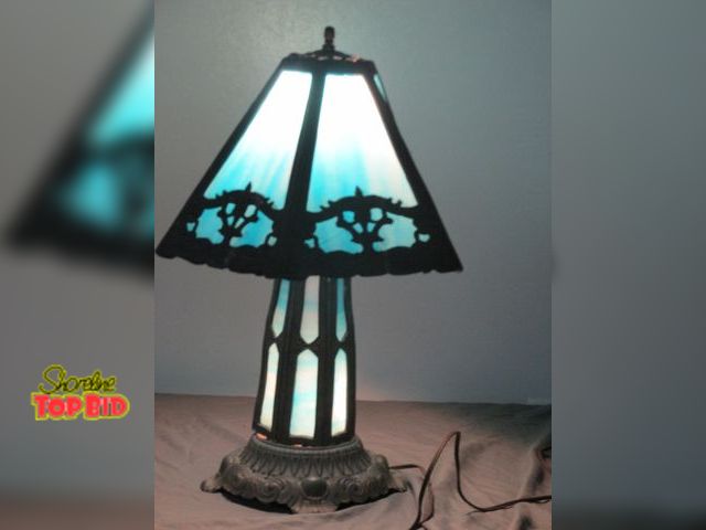 Lot 59-10023 - 20" tall brass and blue tinted glass lamp.  It has 4 selections for the light switch, base lit up on...