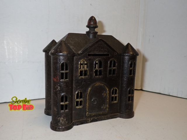 Lot 59-14102 - Antique Cast Iron Late Century "Villa" Still Bank by Kyser &amp; Rex featuring a turreted manor hous...