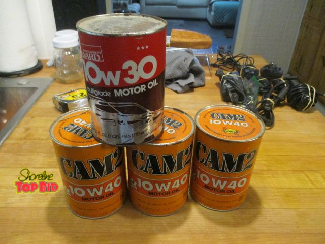 Lot 59-92049 - 8 vintage oil cans full. Sunoco